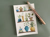 Potted plants postcard, watercolor painting on green desk with pen