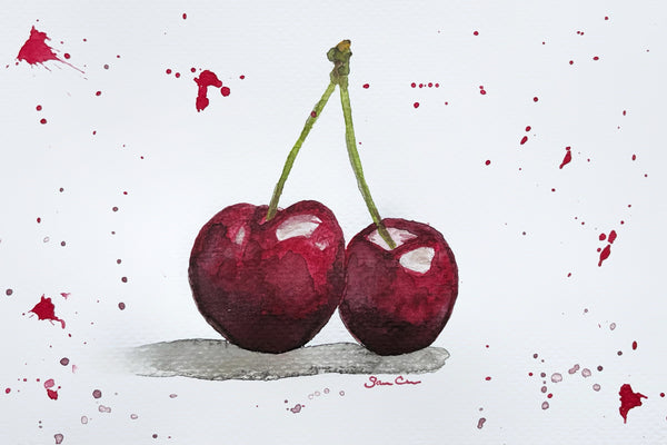 Watercolor artwork of two cherries with stems and paint splashes