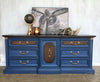 Navy blue dresser with dark java stained wood drawer fronts and top and bold copper hardware