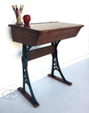 Vintage wooden school desk with iron scroll legs